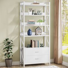 a white book shelf with books and plants on it in front of a large window