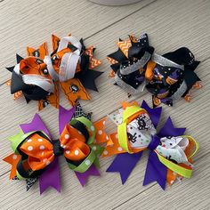 four halloween hair bows laying on top of each other