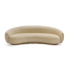 the curved sofa is made from leather and has a rounded backrest that matches the rest of the couch