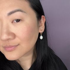 These dainty glass pearl drops are sublime! A must for your accessory closet, they can be worn every day or with glam formal wear and the like. The charms hang from elegant 14k gold-filled hoops and are removable so you can wear the hoops on their own—two earrings in one! Try them with the 15mm hoops for a classic, every day look, or go for a more statement-making look with large 34mm hoops. They're so versatile and perfect for travel! Looking for other hoop sizes? Shop them here. Charm measures Delicate Teardrop Hoop Earrings For Everyday, Feminine Teardrop Pearl Earrings For Formal Occasions, Feminine Teardrop Pearl Earrings For Formal Events, Formal Feminine Teardrop Pearl Earrings, Delicate Teardrop Pearl Earrings For Pierced Ears, Everyday Teardrop Earrings With Pearl Charm, Pear-shaped Hoop Earrings For Gifts, Feminine Teardrop Pearl Drop Earrings, Delicate Teardrop Pearl Earring