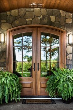 the front door to a home with two potted plants