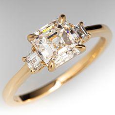 a yellow gold ring with an assorted cut diamond