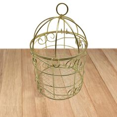 a small metal birdcage sitting on top of a wooden floor