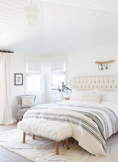 an instagramted photo of a bedroom with white furniture and decor on the walls