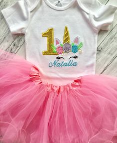 "Unicorn birthday outfit done in your choice of tutu skirt color. Personalized with her name is photo ready to wear for her day or perfect birthday gift for that little girl. This is a shirt they can wear all year long, not just on their special day. Unicorns are the trendiest party theme of the year.. so makes a great gift This outfit is great for photo shoots, family gatherings or parties. Personalization is Always Free at my shop! Just let me know what you would like to add. Fabric used in ap Cute Unicorn Print Tutu Dress For Birthdays, Pink Unicorn Print Tutu Dress For Birthday, Cute Unicorn Print Tutu Dress For Birthday, Cute Tutu Dress With Unicorn Print For Birthday, Pink Tutu Dress With Unicorn Print For Birthday, 1st Birthday Shirt Ideas, Unicorn 1st Birthday, Unicorn Skirt, Unicorn First Birthday