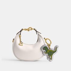 Coach mascot Rexy adds a rebellious attitude to a set of keys or a favorite bag. Crafted of smooth leather it reverses to our Signature canvas. | Coach Rexy Bag Charm With Signature Canvas - Women's - Brass/chalk Coach Bag Charm, Preppy Car Accessories, Preppy Car, Signature Canvas, Mini Purse, H Style, Purse Accessories, Coach Purses, Coach Bags