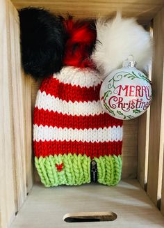 This Christmas hat is hand knit and the Pom color is optional. You can chose red white or black. Very warm and has some slouch to be able to have a ponytail under Care instructions:  Remove Pom and tag. Hand was and lay flat to dry. Reattach Pom and tag. Enjoy! Red Mini Hat For Winter Gift, White Hat One Size Gift, White Winter Hats As Gifts, Winter White Crochet Hat As Gift, White Crochet Hat For Winter Gift, Casual White Christmas Hat, White Crochet Beanie Hat As Gift, Hand Knitted Mini Hats For Winter, White Hand Knitted Hat As Gift