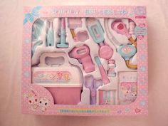 a pink and white box filled with lots of toys