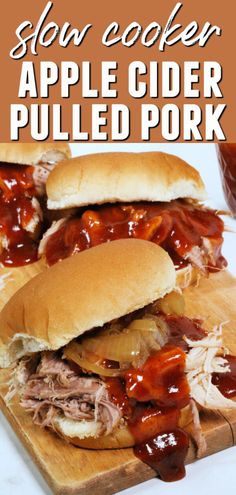 slow cooker apple cider pulled pork sandwiches on a cutting board with bbq sauce