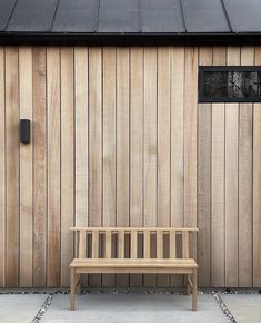 a wooden bench sitting in front of a building