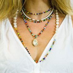 "Bright, vibrant beads make this necklace perfect addition to your summer sundress or a white blouse. African glass beads and white freshwater pearls are hand knotted along the silk cord to create a colorful and bright strand. Alone or layered with your favorites, this necklace exudes a playful, eclectic bohemian elegance. Necklace: 43\" Layer this necklace with: https://www.etsy.com/listing/637252353/baroque-pearl-and-turquoise-necklace?ref=shop_home_active_2 You might also like: https://www.et Summer Multi-strand Colorful Beaded Necklaces, White Tiny Beads Strand, Elegant White Shell Necklace For Summer, White Beaded Strand Beads, White Tiny Beaded Necklaces For The Beach, Summer Multi-strand Beaded Necklaces, White Necklace For Festivals, White Round Bead Necklaces For The Beach, Multicolor Beaded Necklace With Pearl Charm