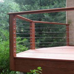 a wooden deck with metal rails and posts