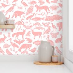 a pink wallpaper with animals and birds on it in a white kitchen area next to a window