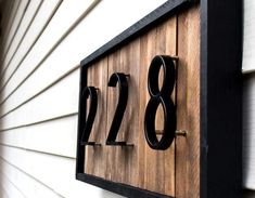 a house number sign mounted to the side of a building