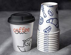 a stack of coffee cups sitting next to each other on top of a gray surface