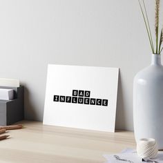 the word dad is spelled in black on a white background art boarder next to a potted plant