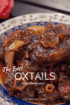 the best oxtails recipe is made with beef, onions and peppers on a blue and white plate