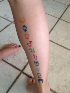 a woman's leg with colorful letters on it