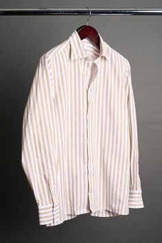 A bespoke shirt crafted from a textured cotton blend fabric in an oversized candy stripe. The larger striped pattern gives it a punch of style, making it a great casual shirt that can be worn with chinos or jeans - or under suits and jackets. The lightweight fabric drapes effortlessly, making it an ideal choice for those seeking a sophisticated yet relaxed look. Striped Shirt With Relaxed Fit And Spread Collar, White Linen Top With Vertical Stripes, Classic Striped Linen Tops, Cotton Tops With Vertical Stripes And Spread Collar, Striped Linen Tops For Work, Classic Relaxed Fit Yarn-dyed Shirt, Classic Yarn-dyed Shirt In Relaxed Fit, Bespoke Shirts, Casual Night Out