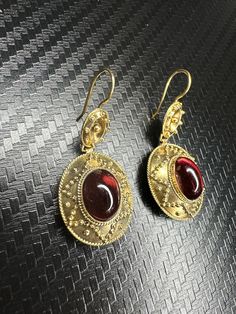 Beautiful 14k Yellow Gold Garnet Earrings Material: 14k Yellow Gold Gemstone: Garnet Type: Fishhook Total weight: 5.6 grams Time period of origin: circa 1870's Country of origin: England We have a GIA gemologist on our team. All jewelry items are authenticated. Ornate Yellow Gold Oval Earrings, Ornate Gemstone Earrings For Formal Occasions, Exquisite Handmade Yellow Gold Earrings, Gold Oval Earrings With Elegant Design, Formal Red Brass Earrings, Elegant Oval Gold Earrings, Elegant Oval Hallmarked Earrings, Gold Gemstone Earrings For Formal Occasions, Luxury Brass Earrings