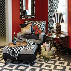 a living room with red walls, black and white checkered flooring and furniture