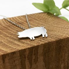 The Silver Pig Necklace has been hand crafted from start to finish in my New Forest based studio. The Pig has been hand pierced and polished for a shine finish.  Dimensions: The Piggy is 1mm thick silver and measures 2.8cm at the widest point.  18inch chain  Hallmarked sterling silver at the Birmingham Assay Office. Please read delivery and returns policy: Delivery  All orders will be sent out using UK Royal Mail signed for delivery and will require a signature. Once payment is complete, I will Silver Sterling Silver Large Pendant Jewelry, Metal Necklace With Polished Finish For Gift, Polished Metal Necklace For Gift, Silver Stainless Steel Jewelry For Jewelry Making, Silver Minimalist Engraved Necklace, Shiny Sterling Silver Jewelry, Silver Minimalist Jewelry With Polished Finish, Minimalist Silver Jewelry With Polished Finish, Minimalist Engraved Silver Necklace