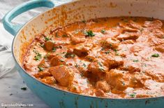 a blue pan filled with meat and sauce