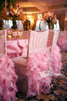 two chairs covered in pink ruffles sit on the floor next to each other