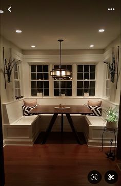 a room that has some lights on the windows and a bench in front of it