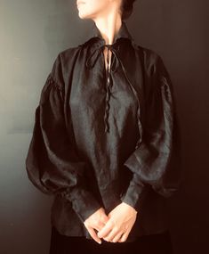 Beautiful Regency style unisex oversized shirt made of 100% fine linen in black color. One size, will fit Small, Medium, Large, Extra Large. Care: hand wash, hang dry. Please message if you have any questions. This undershirt is designed with original Victorian style pattern with a few modern modifications Same item in different colors: https://www.etsy.com/listing/1263883926/regencyvictorianrenaissancemozartpirateb?ref=listings_manager_grid Bust 54" Hip 54" Length 30" Model is size M and 5.9' D Black Gothic Tops For Larp, Bohemian Black Long Sleeve Shirt, Bohemian Long Sleeve Tops For Larp, Black Bohemian Relaxed Fit Shirt, Victorian Shirt, Poet Shirt, September Fashion, Pirate Shirts, Dressy Casual Outfits