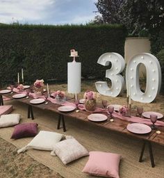 the table is set up with pink and white plates