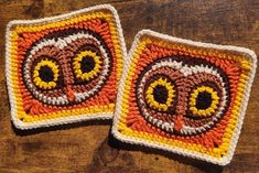 two crocheted coasters sitting on top of a wooden table