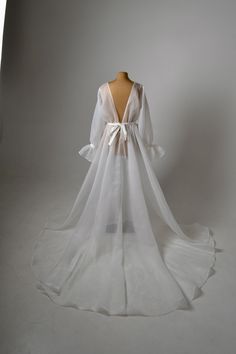 the back of a white wedding dress on display