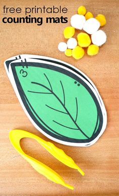 a printable counting mat with yellow scissors and candy corn on the table next to it