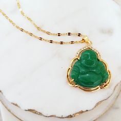 MATERIAL: 18k gold filled, genuine jade, and cubic zirconia; non-tarnish ✔ Non Tarnish ✔ Handmade ✔ Hypoallergenic ✔ Waterproof COLOR: green and gold CHAIN LENGTH: 18 inches unless otherwise requested Green Gemstone Necklace For Good Luck, Jade Necklace For May Birthstone With Spiritual Style, Spiritual Jade Necklace For May Birthstone, Spiritual Gold Aventurine Necklace, Spiritual Aventurine Gold Necklace, Gold Aventurine Necklace For Gift, Gold Aventurine Necklace As Gift, Jade Buddha Necklace, Jade Buddha