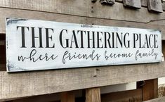 a wooden sign that says the gathering place where friends become family