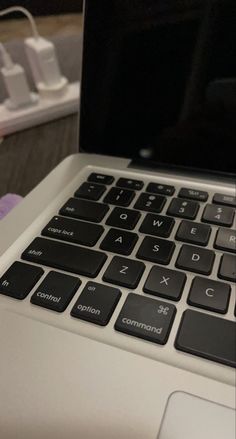 an open laptop computer sitting on top of a table