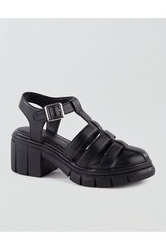 Vegan synthetic upper/Adjustable buckle closure/Fisherman-style silhouette/Round toe/Elevated platform heel/Not eligible for promotions | Only ships within the USA Womens Fisherman Sandals, Black Synthetic T-strap Sandals With Buckle Closure, Trendy T-strap Sandals With Buckle Closure, Platform T-strap Synthetic Sandals, Synthetic T-strap Sandals With Buckle Closure, Synthetic T-strap Heels With Buckle Closure, Fisherman Style, Black Platform Sandals, Sandals Platform