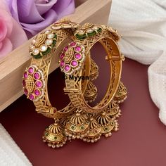 Ruby kundan Kada bangle with jhumka. Inspire your style with traditional rajwadi kada handcrafted from premium quality kundan, stone and pearl to create elegant piece of jewelry from our Indian wedding collection.   All orders Ship same day if placed before 4:00 PM EST Create beautiful memory for any occasion with elegant jewelry for your loved ones You will receive carefully packaged items in jewelry box, ready to give memorable gift  to your Wife, mother, sister  friend or collegue. All orders Heavy Kundan Bangle For Wedding, Cutdana Kundan Bangle For Wedding, Kundan Cutdana Bangle For Wedding, Wedding Tilla Bangle, Heavy Bollywood Bangle For Weddings, Festive Wedding Bangle With Tilla Detail, Meenakari Temple Jewelry Bangle, Temple Jewelry Meenakari Bangle, Heavy Bangle For Navratri