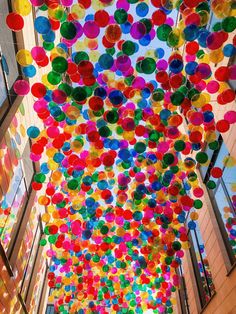 the ceiling is decorated with multicolored balloons