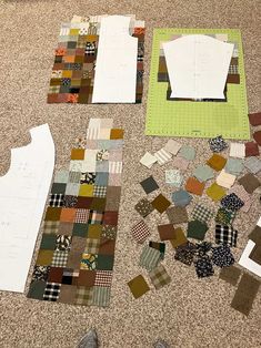 several pieces of fabric laid out on the floor next to each other and some paper