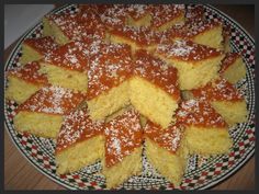 several pieces of cake on a plate covered in powdered sugar