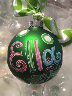 a green ornament with the word holiday written on it