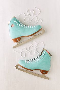 two ice skates sitting on top of a white surface with holes in the middle