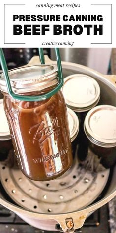 a canning jar filled with canned beef broth sitting on top of an open stove