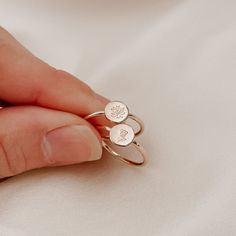 The latest offering in our birth flowers collection is the dainty birth flower disc ring. Holding a meaningful birth flower, each ring is sized to fit and made from scratch with the utmost love and care. Each mini birth flower, hand stamped on a tiny disc and set on a round ring band Available in sizes 2 US to 15 US Need help with sizing? Look at our size guide or purchase our ring sizer Due to its handmade nature, there may be some colour variances where the solder seam is Each Stamp + Shine pi Dainty Sterling Silver Birth Flower Ring, Dainty Birth Flower Ring, Dainty Adjustable Flower Ring, Adjustable Dainty Flower Ring, Personalized Dainty Flower Ring, Minimalist Adjustable Flower Ring With Birth Flower, Minimalist Adjustable Birth Flower Ring, Minimalist Birth Flower Ring, Dainty Personalized Flower Ring