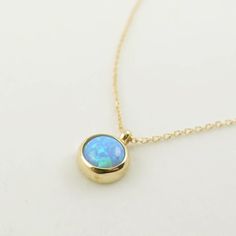 "\"Blue Opal Necklace | Opal Gemstone Pendant | Minimal and Elegant Gold Necklace for Daily Use | Anniversary Valentine Gift | Gift for Her\" In the Middle Ages, opal was considered a stone that could provide great luck because it was believed to possess all the virtues of each gemstone whose color was represented in the color spectrum of the opal. It was also said to grant invisibility if wrapped in a fresh bay leaf and held in the hand. This minimal necklace is a perfect minimal gift for your Elegant Opal Clavicle Chain Jewelry, Fine Jewelry Opal Round Necklaces, Opal Gemstone Round Pendant Necklace, Tarnish Resistant Opal Jewelry For Gifts, Tarnish Resistant Opal Jewelry Gift, Elegant Round Opal Necklace, Tarnish-resistant Opal Jewelry Gift, Opal Birthstone Necklaces, Opal Birthstone Round Necklaces