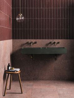 a bathroom with two sinks and three soap dispensers hanging from the wall