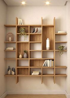 a wooden shelf with books and vases on it in the corner of a room