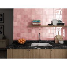 a kitchen with pink tiles on the wall and wooden cabinets, along with a sink